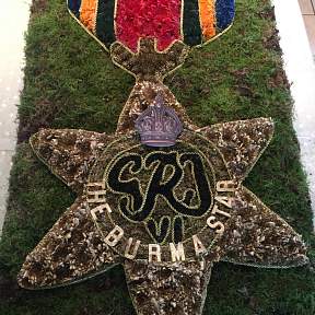 funeral tribute in the shape of the Burma Star