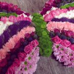 Pink and purple butterfly shaped funeral tribute